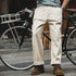 Vintage 11.2oz white cottonseed men's loose fit straight cargo pants, styled with a bike.